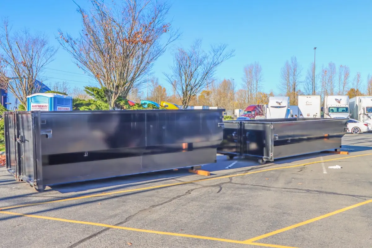 Professional dumpster rental service with roll-off container on residential driveway in Fruit Cove